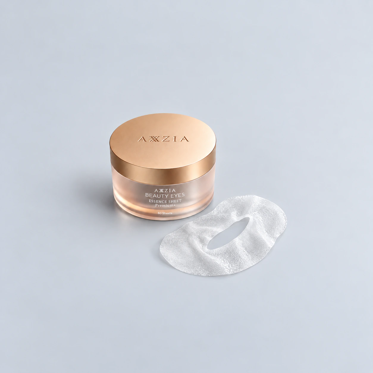 Beauty Eyes Essence Sheet Premium Plus jar with a complete moist fibrous eye sheet on a gray studio surface